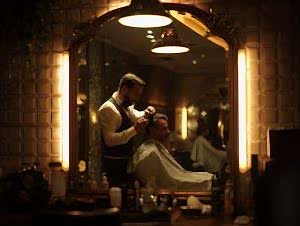 “Barber styling men’s haircut in Istanbul salon with modern warm lighting”