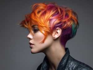 Bold edgy female haircut with vibrant color