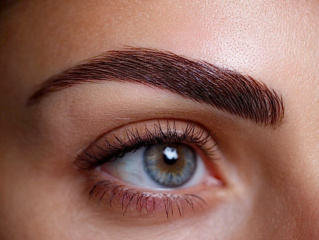 Healed natural brows after microblading aftercare showing even pigment and soft strokes